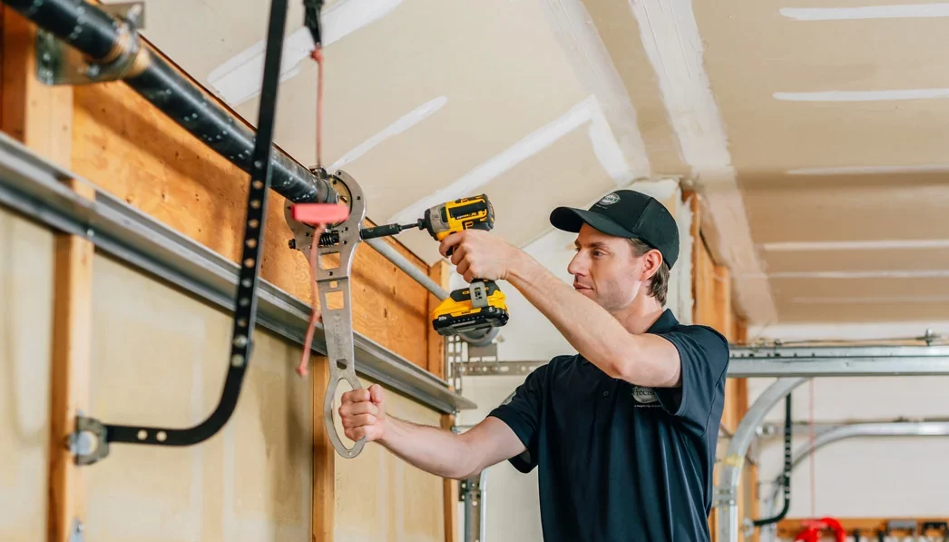 Precision Garage Door technician repairing a spring Precision Garage Door technician repairing a spring